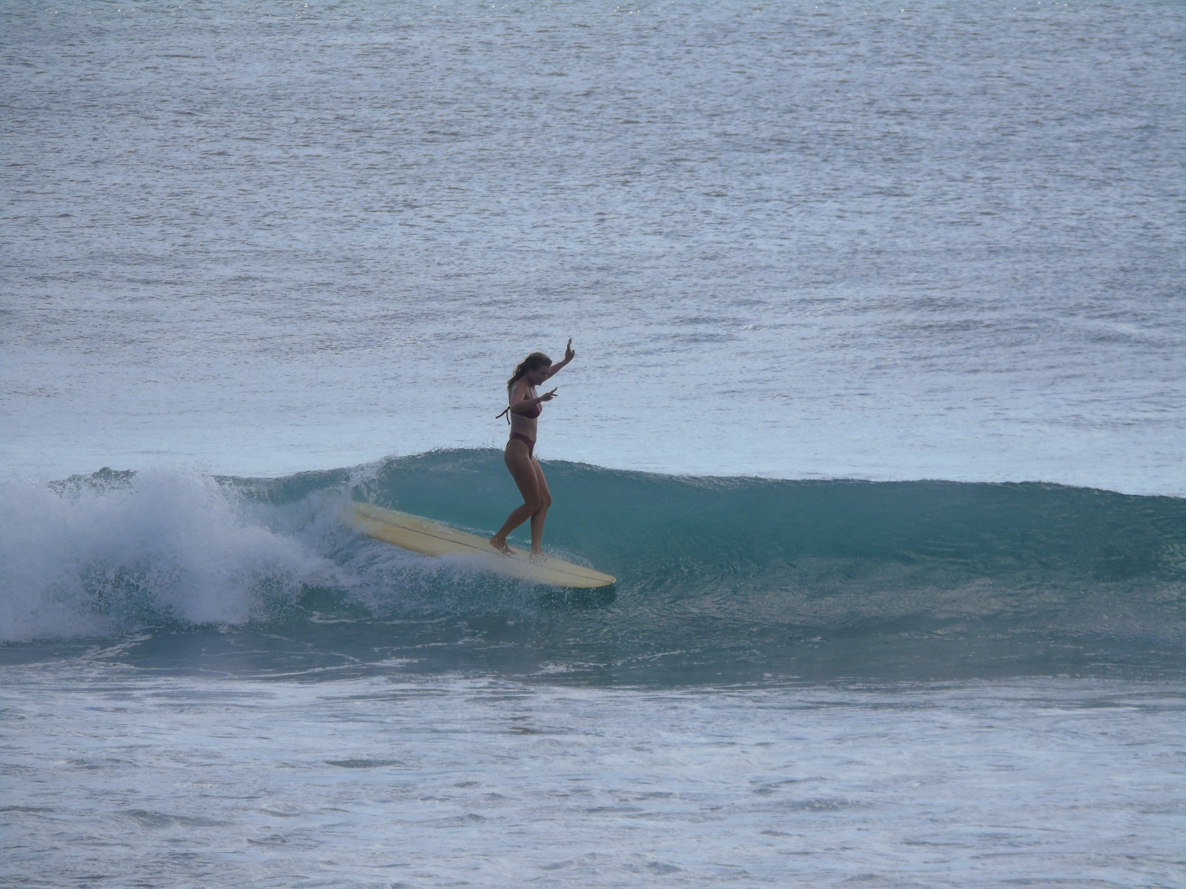 Surfer riding a wave at Uluwatu, Bali