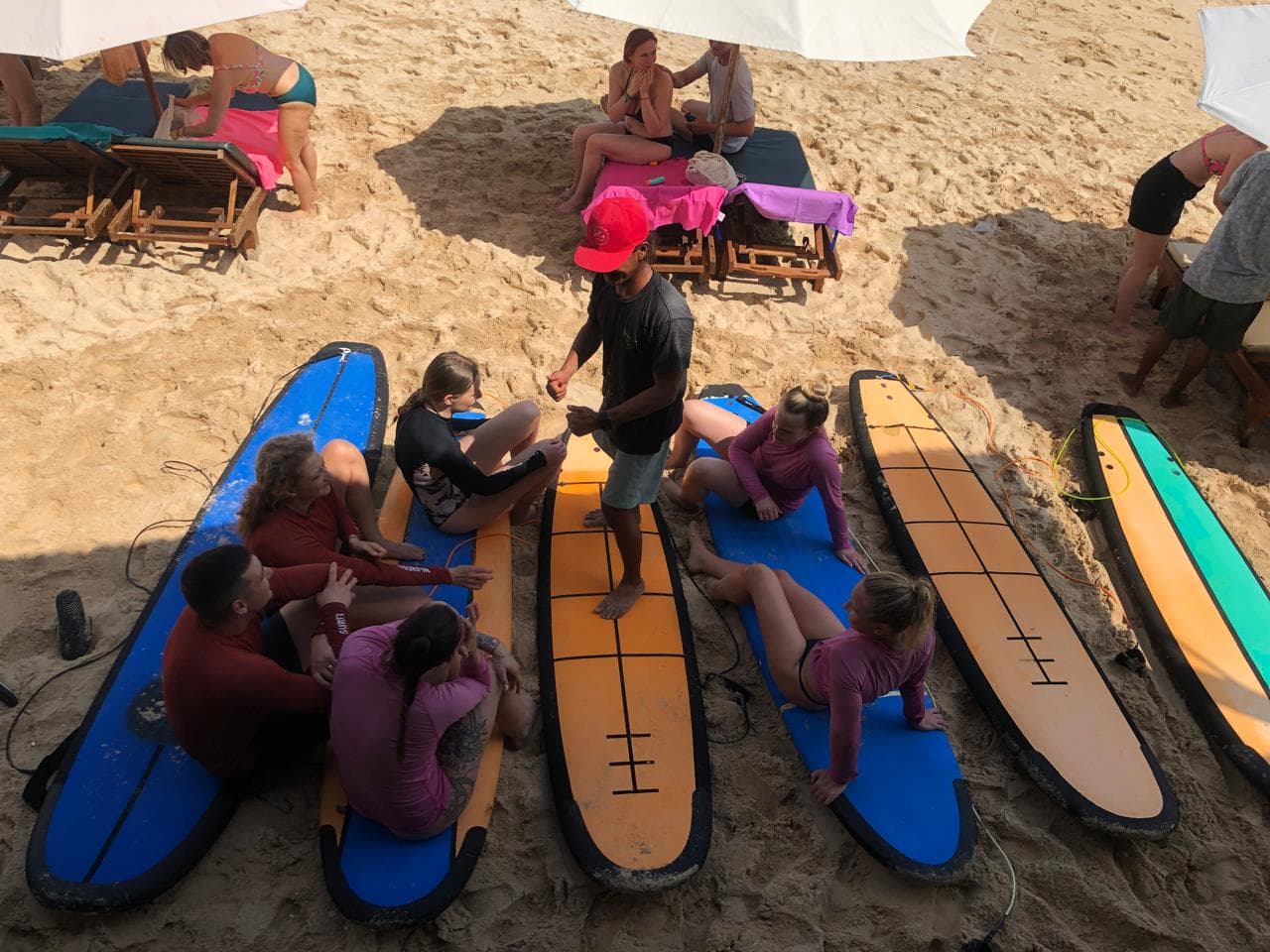 Group surf lesson briefing on the beach at Balangan, Uluwatu