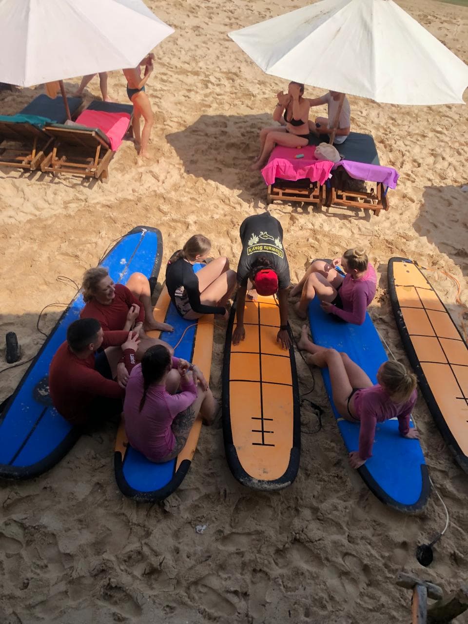 Semi-private surf lesson for two students on the sand at Uluwatu, Bali